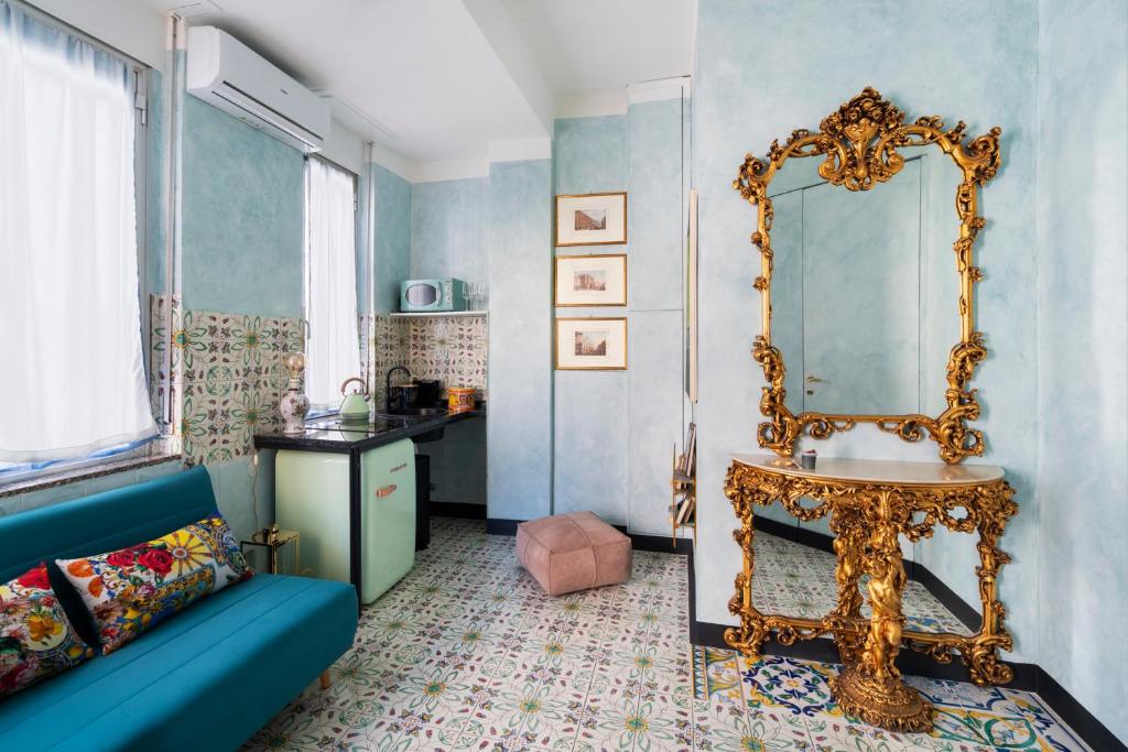 a living room with a blue couch and a mirror at Dream Suite in Milan