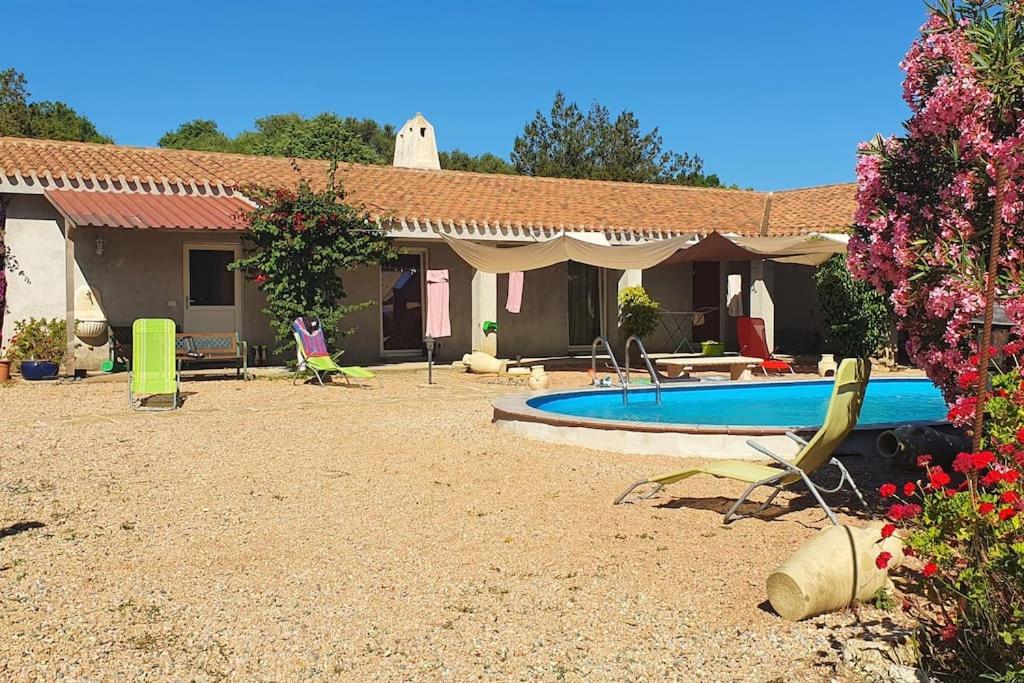 a house with a swimming pool in the yard at Ferienappartement Angelika in Arzachena