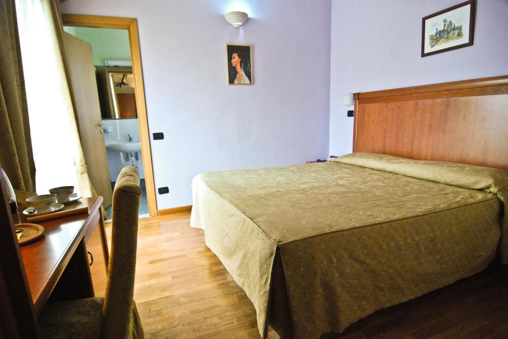 Postel nebo postele na pokoji v ubytování Hotel Picchio