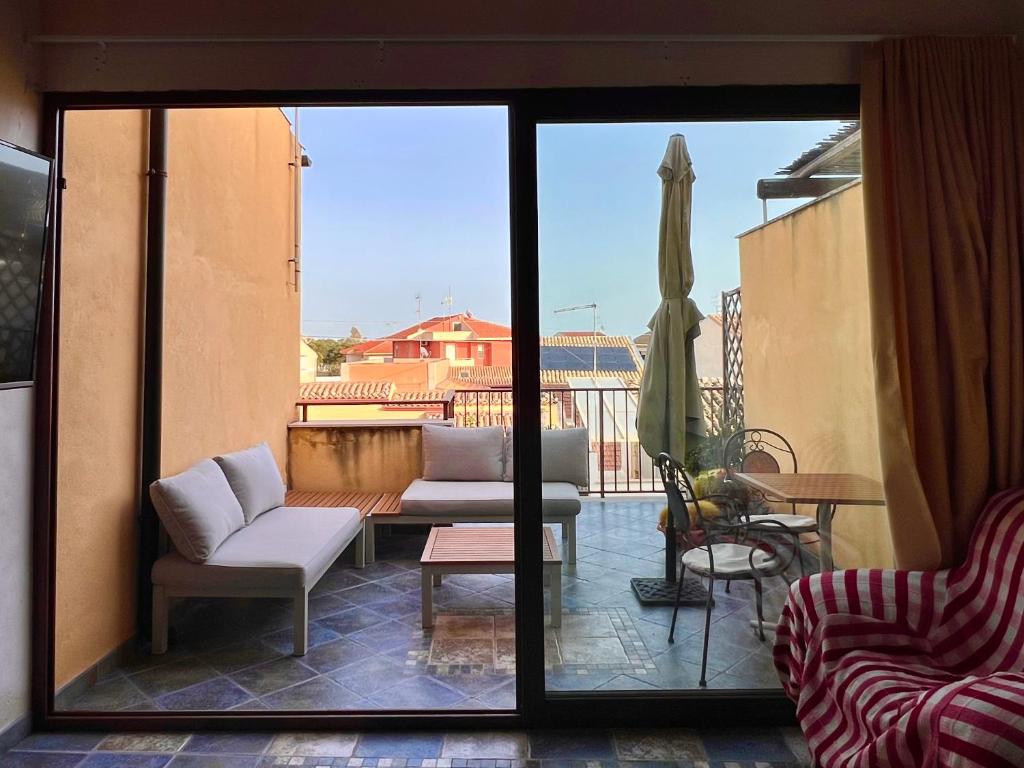 Blick auf eine Terrasse mit einem Sofa und einem Tisch in der Unterkunft Casa Melina in Marina di Ragusa