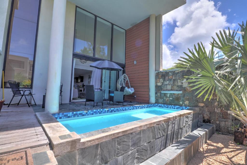 a swimming pool in the backyard of a house at SG5 l Le Turquoise - third line building - Beachfront Residence in Cap Malheureux