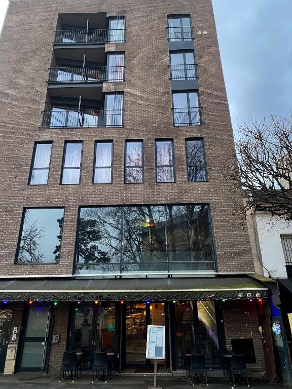 un grand bâtiment en briques avec des fenêtres sur une rue dans l'établissement Chambres Pasteur, à Montreuil