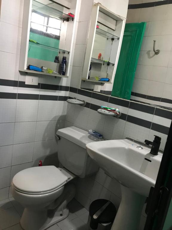 a bathroom with a toilet and a sink at “Fluffy loft” in Santiago