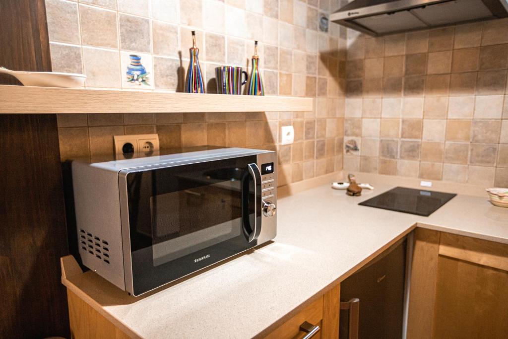 A kitchen or kitchenette at apartamentos rurales marrubiu-playa de Poo