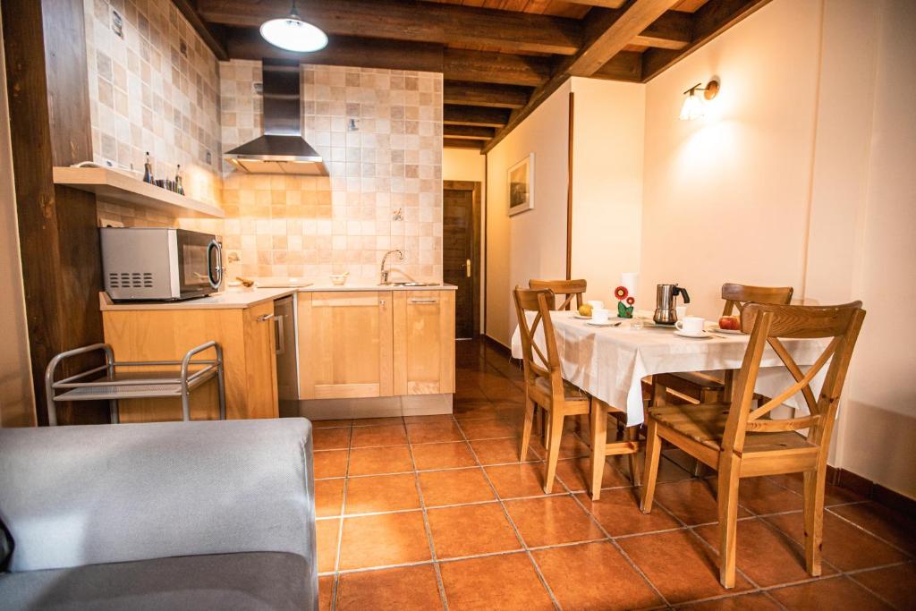 A kitchen or kitchenette at apartamentos rurales marrubiu-playa de Poo