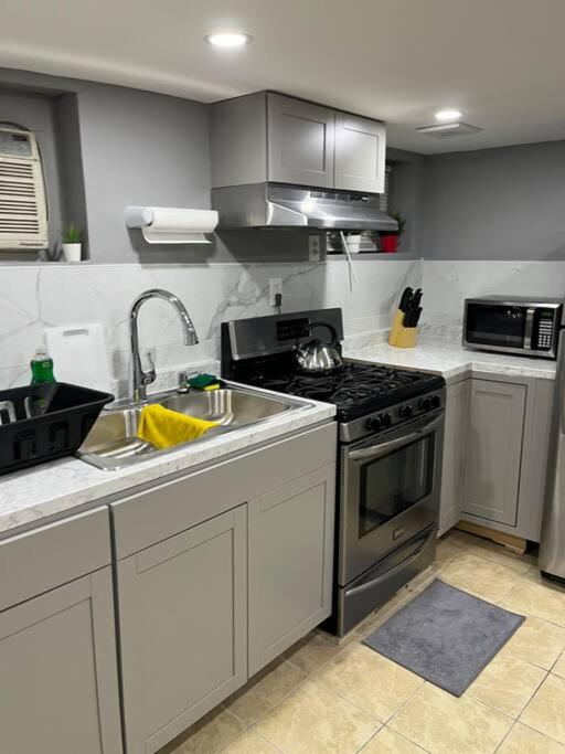 a kitchen with a sink and a stove at 2 Bedroom Apartment By Airport in Hillside