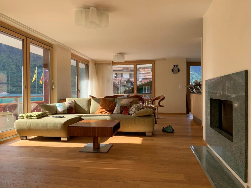 a living room with a couch and a table at Seehaus / lake view apartment in Iseltwald