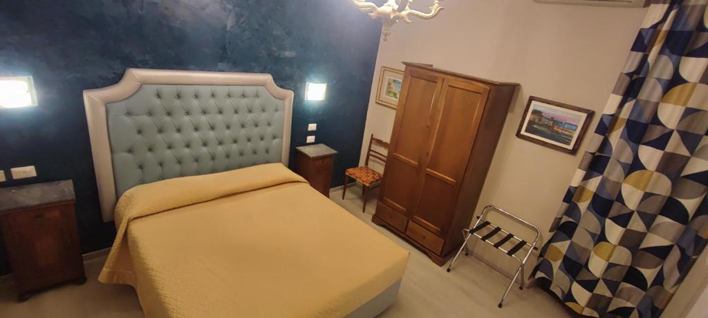Postel nebo postele na pokoji v ubytování Hotel Merlini