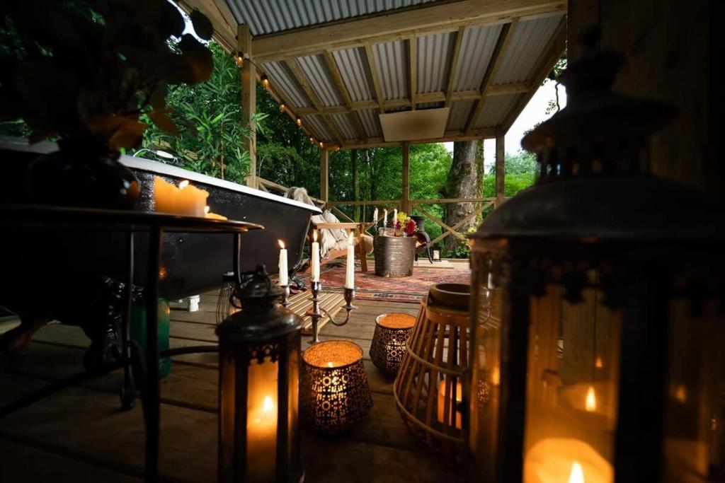 a group of candles sitting on a patio with a table at Shepherd's Rest Luxurious Hideaway in Glasgow