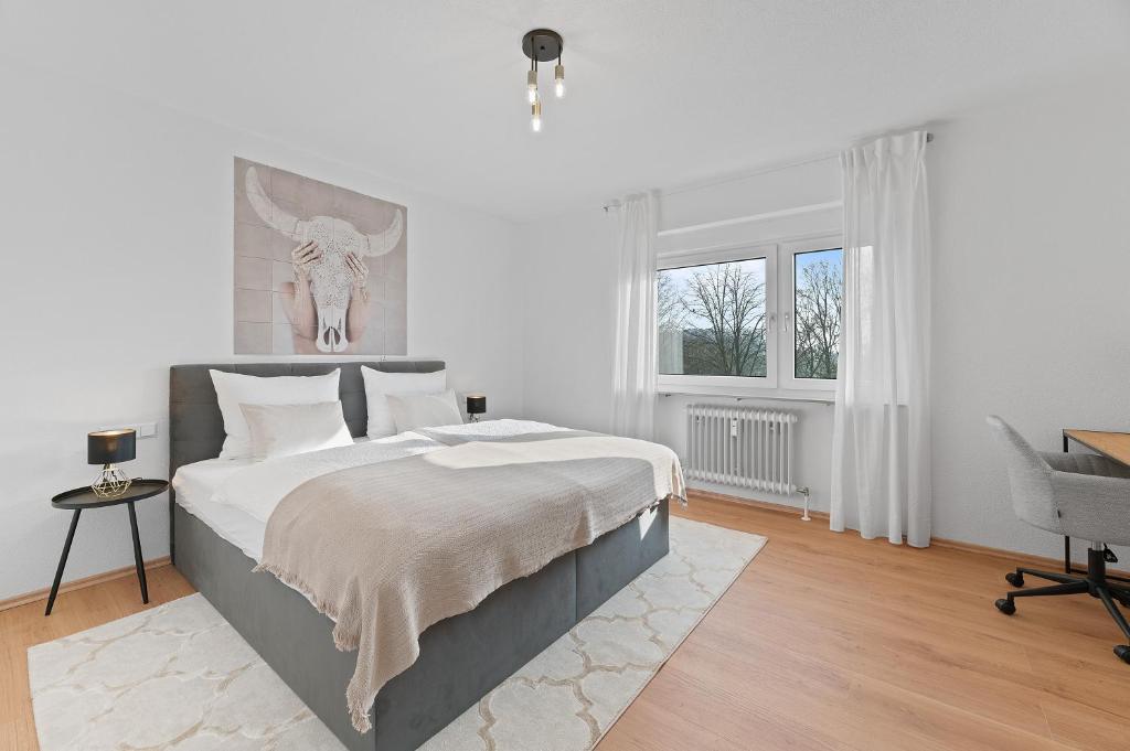 a white bedroom with a bed and a desk at ☆Roomfall: Design Suite am Kurpark in Bad Rappenau