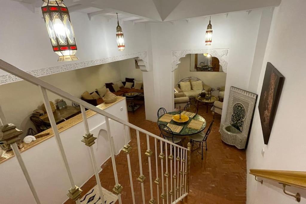 a room with a staircase and a living room at Dar Dada in Safi