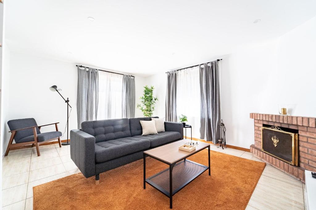 a living room with a couch and a fireplace at Flat Armada II - Apartamento T5 junto ao BragaParque in Braga