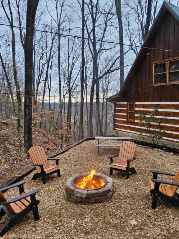 a fire pit with two chairs and a cabin at Meadows Way 3378 in Pigeon Forge