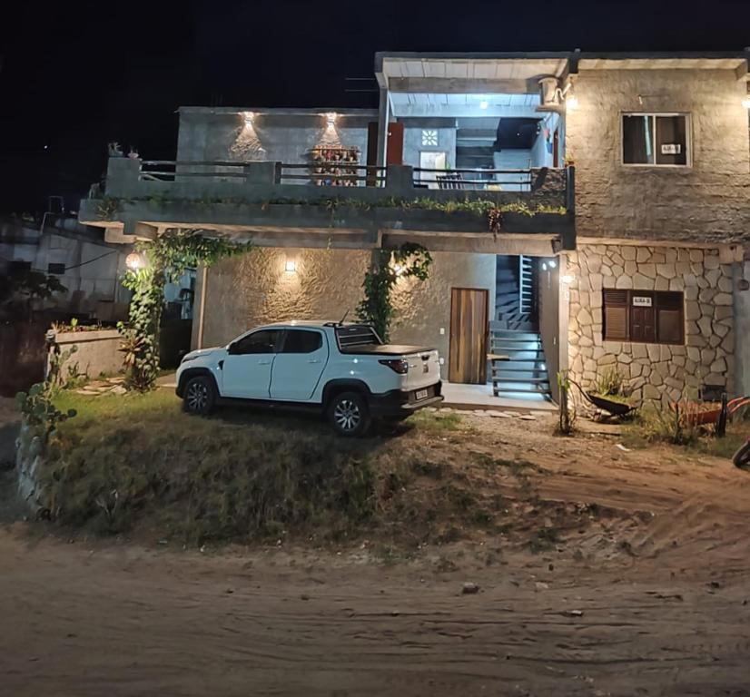 biała ciężarówka zaparkowana w nocy przed domem w obiekcie Casa Rustica w mieście Baía da Traição