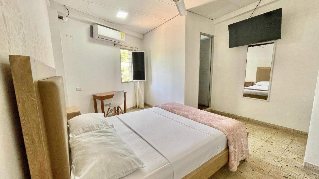 Postel nebo postele na pokoji v ubytování Hotel Balcon de Oro Curumani
