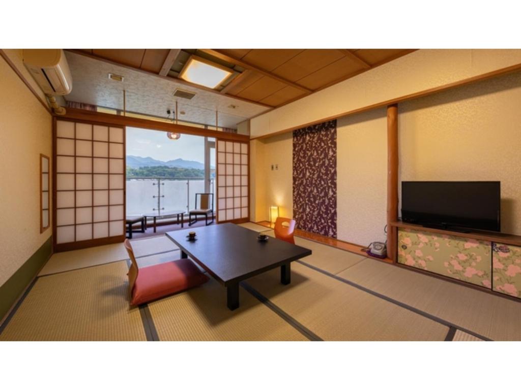 a room with a table and a television in a room at Mikuma Hotel - Vacation STAY 63475v in Hita