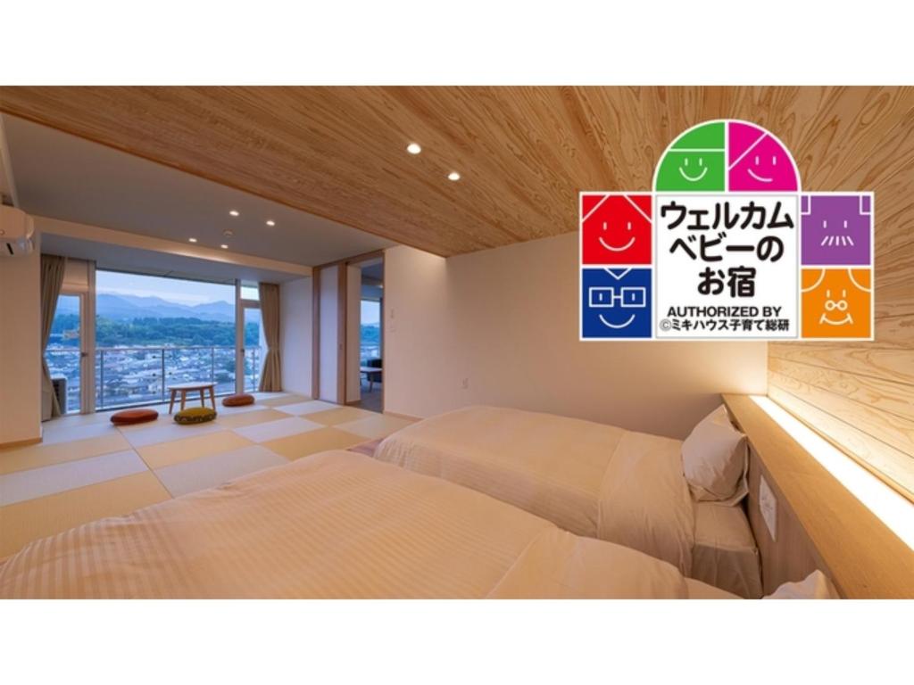 Mikuma Hotel - Vacation STAY 63515v في هيتا: غرفة نوم بسرير وعلامة على الحائط