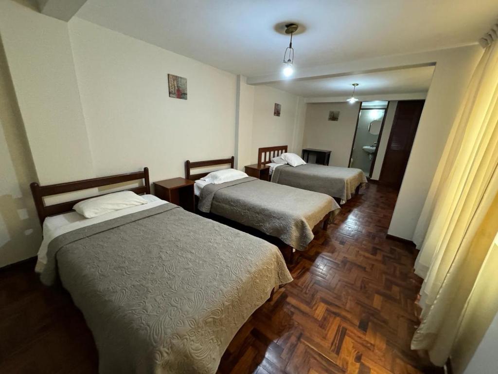 een hotelkamer met 2 bedden in een kamer bij Hotel Los Angeles in Arequipa