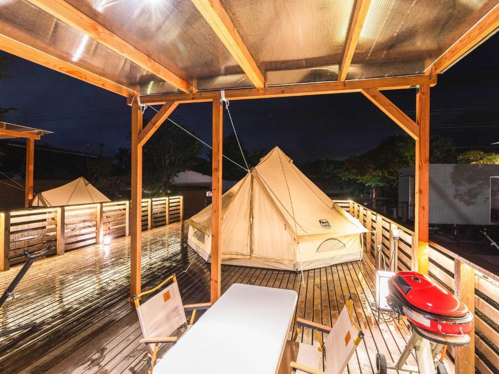 a tent on a deck with a table and chairs at Ashigarashimogun - Glamping - Vacation STAY 75747v in Sengokuhara