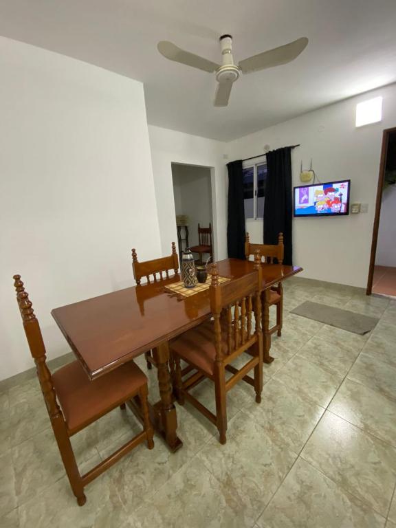 a dining room with a wooden table and chairs at Sarmiento 595 in Paso de los Libres