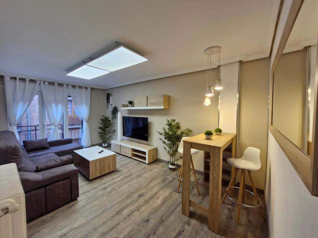 a living room with a couch and a table at Feeling Home Catedral in León
