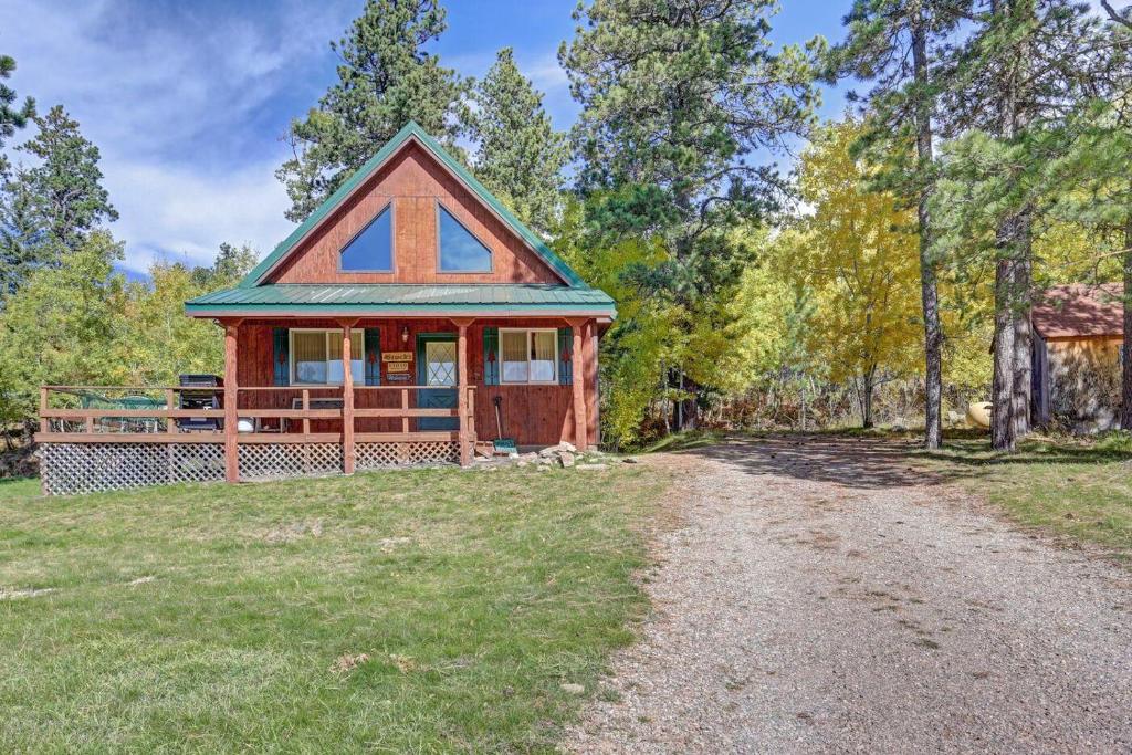 a small house on the side of a dirt road at Cozy Black Hills Retreat in Lead
