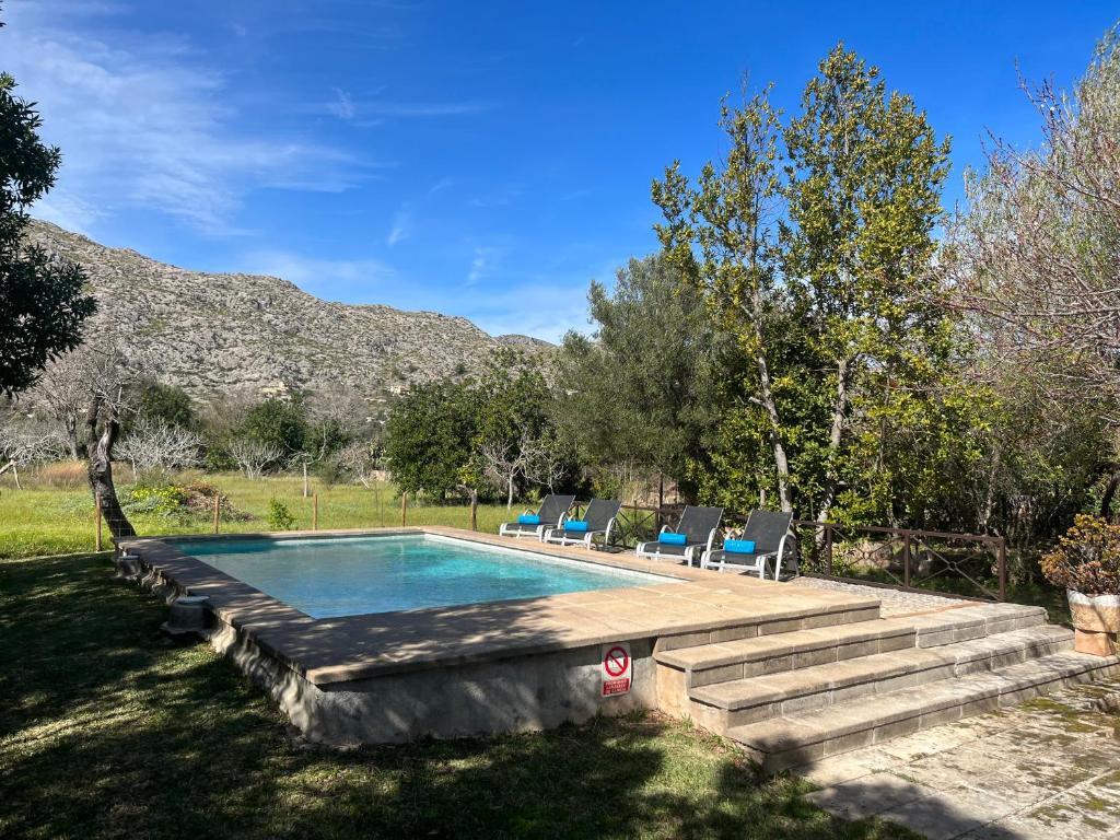 a swimming pool in a yard with chairs around it at Villa Estel - La Goleta Hotel de Mar & Villas in Pollença