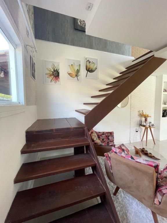 a staircase in a house with a living room at Casa happy day in Angra dos Reis