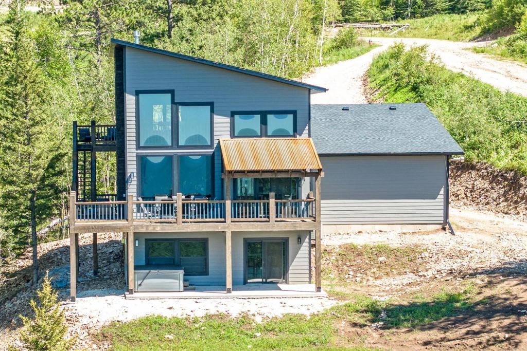 a house with a wrap around porch and a deck at Golden Eagle`s in Lead