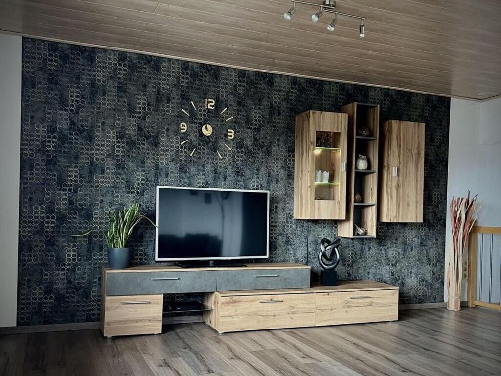 a living room with a flat screen tv on a wall at Holiday apartment Resch in Perlesreut