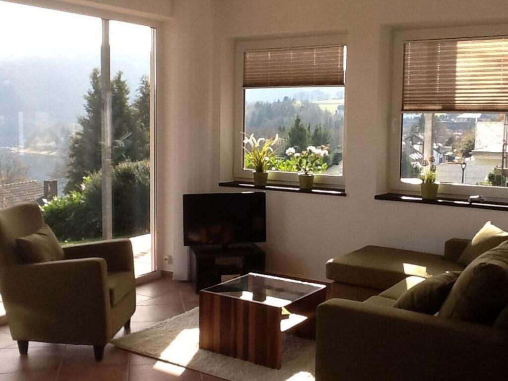 a living room with two couches and a tv at Holiday apartment Rursee in Simmerath
