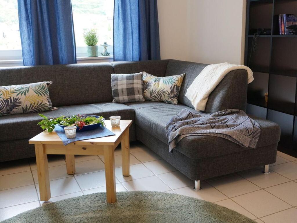 a living room with a couch and a table at Holiday apartment holidays in the forest in Weisenbach