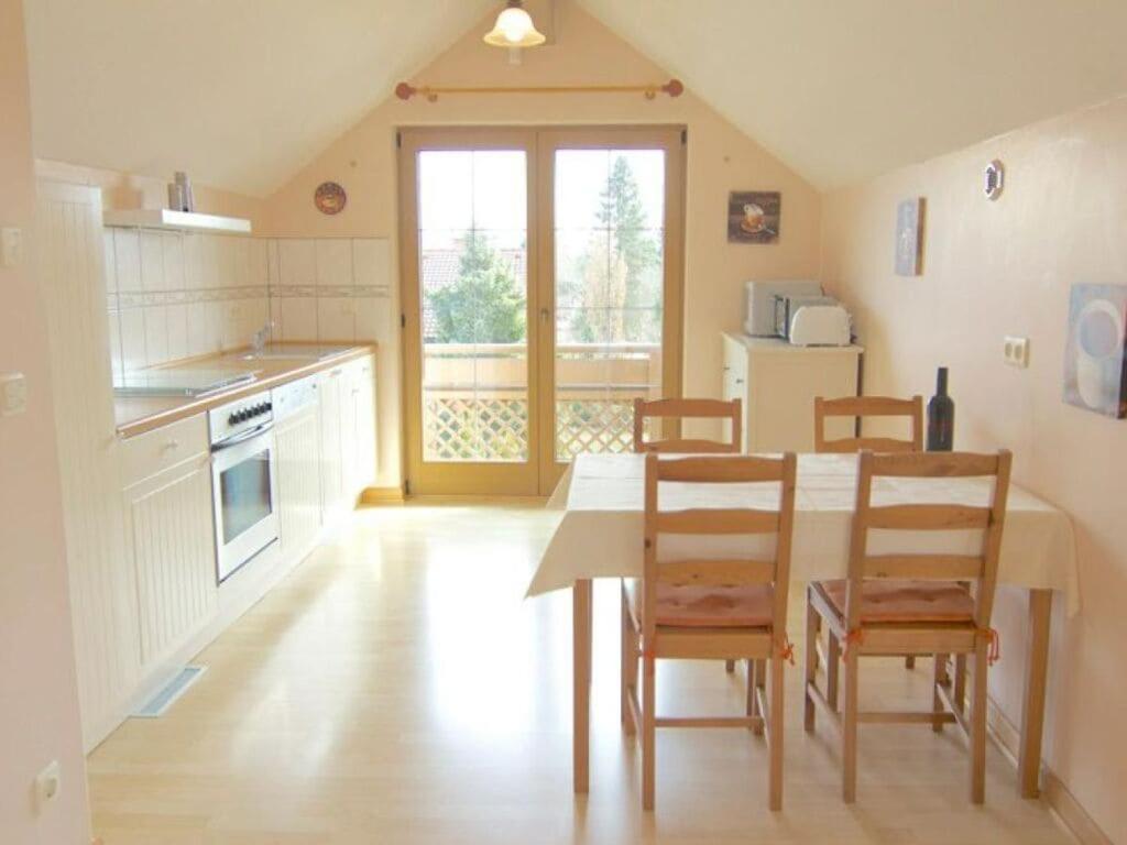 a kitchen with a table and chairs in a room at Holiday apartment Gelting in Gelting