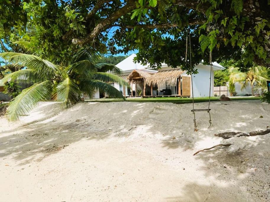een schommel op het strand voor een huis bij Bungalow Miri in Tevaitoa
