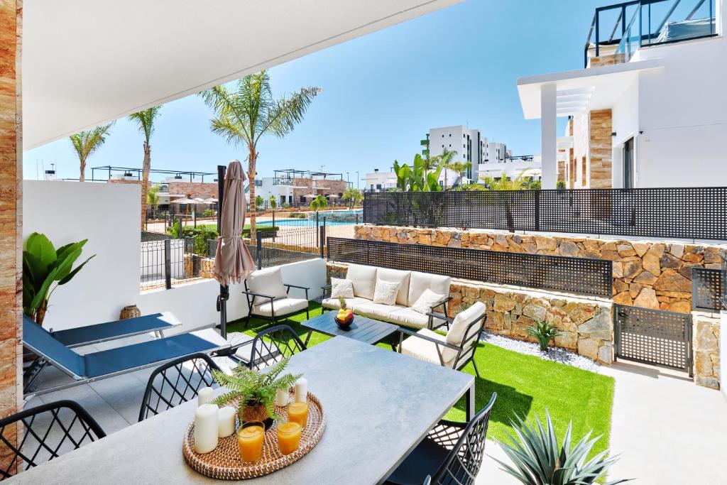 a patio with a table and chairs on a roof at Sunshine in Pilar de la Horadada