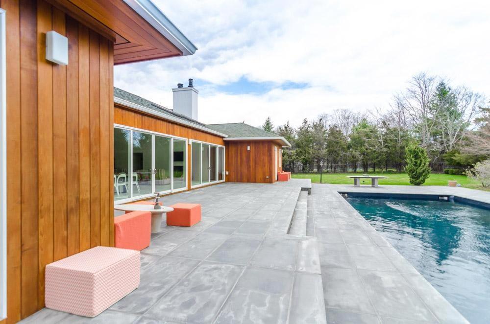 a house with a swimming pool next to a building at West Hamptons Zen retreat in Westhampton