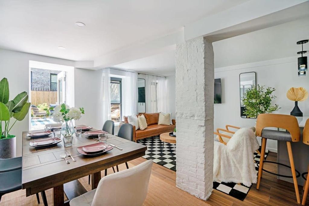 a dining room and living room with a table and chairs at 91-1D 3BR 2baths Duplex with a Private Back yard - GYM in New York
