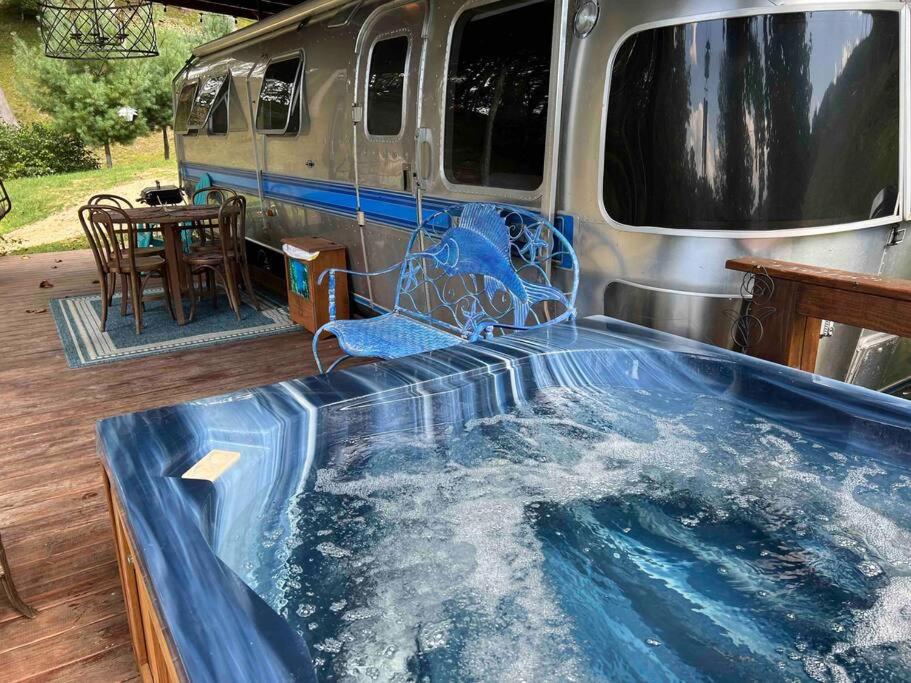 a jacuzzi tub in front of a van at Airstream at a Petting Zoo w/ Hot Tub in Sugar Grove