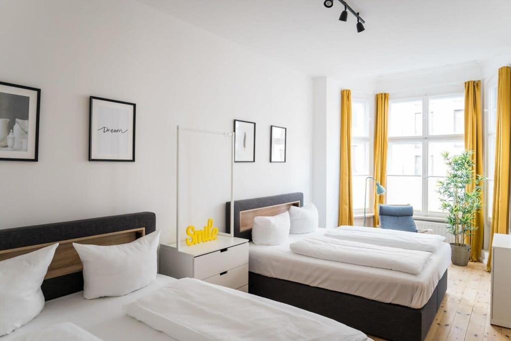 a bedroom with two beds and a mirror at Apartment at Rosenthaler Platz in Berlin