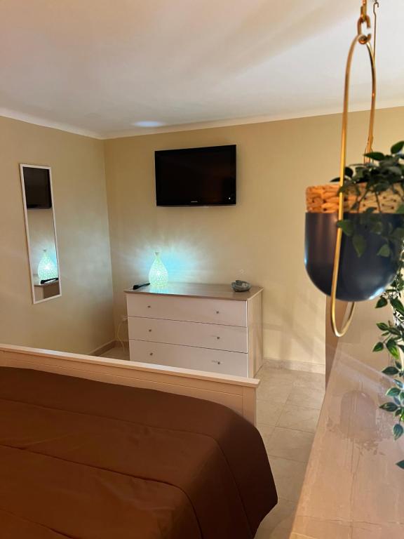a living room with a tv and a dresser at Piazzetta 42 Holiday Room in Trani