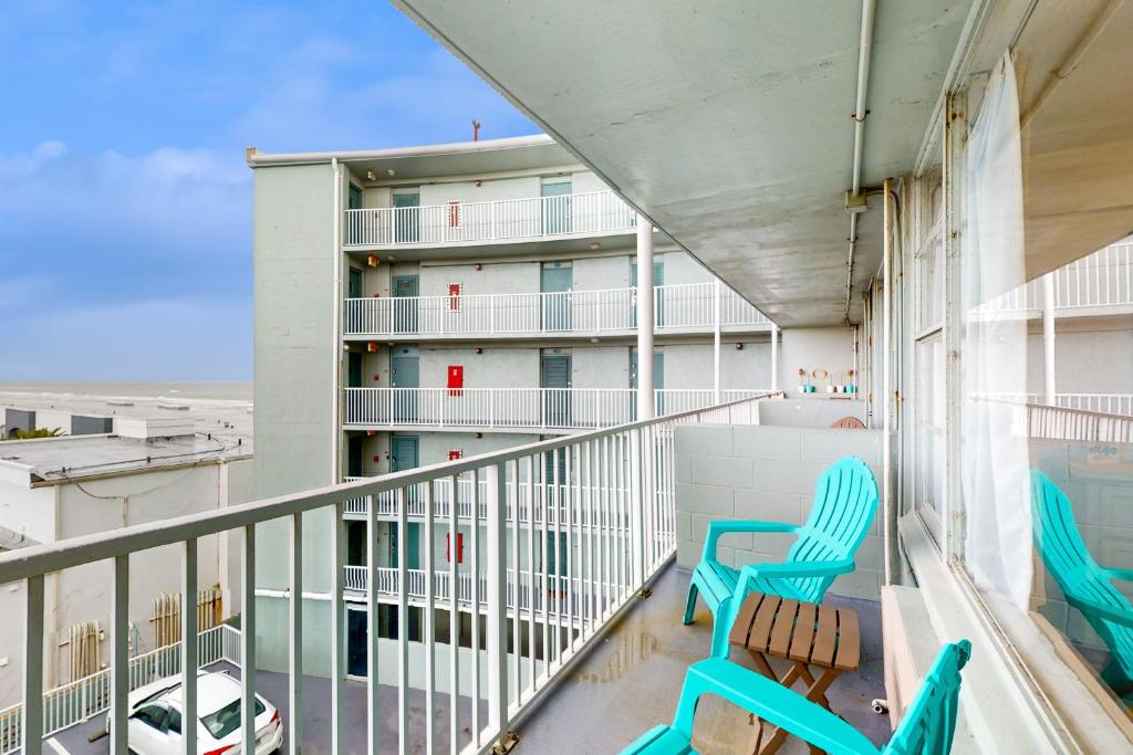 a balcony with two chairs and a building at Daytona Beach Club Unit 523 in Daytona Beach