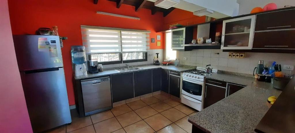 a kitchen with a refrigerator and a stove top oven at Mi lugar in San Carlos de Bariloche