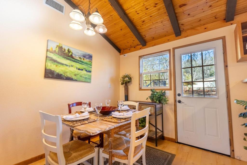 a dining room with a table and chairs and a door at The Hideout at Hills Haven in Wimberley