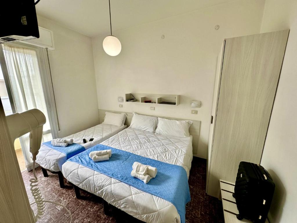 Postel nebo postele na pokoji v ubytování Hotel Napoleon