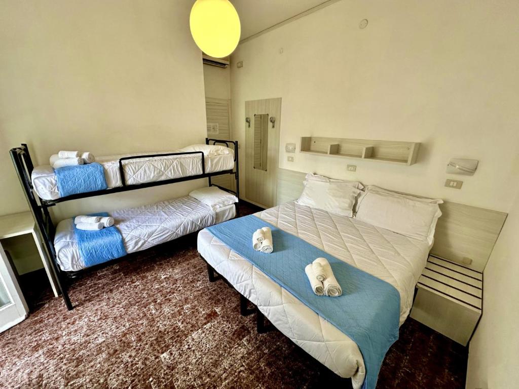 Postel nebo postele na pokoji v ubytování Hotel Napoleon