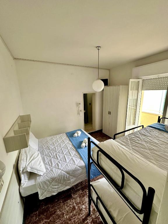 Postel nebo postele na pokoji v ubytování Hotel Napoleon