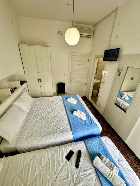 Postel nebo postele na pokoji v ubytování Hotel Napoleon