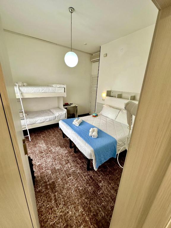 Postel nebo postele na pokoji v ubytování Hotel Napoleon