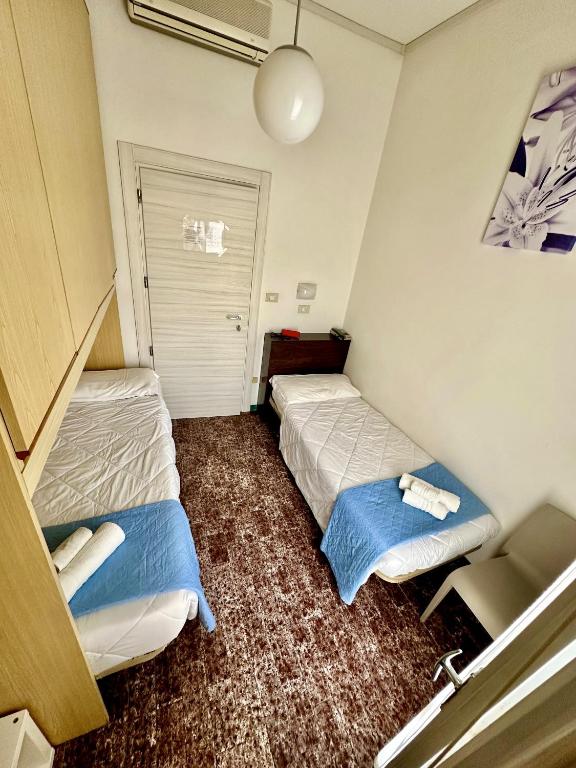 Postel nebo postele na pokoji v ubytování Hotel Napoleon
