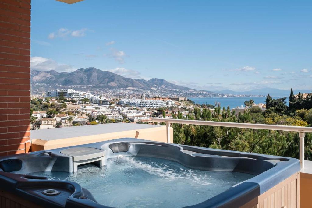 a hot tub on the balcony of a house at Malibu Mansions by the beach by ALFRESCO STAYS in Mijas Costa